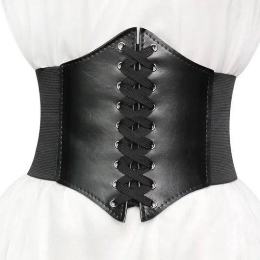 Gothic wide belt corset for women in black faux leather with lace up front worn over a white outfit 