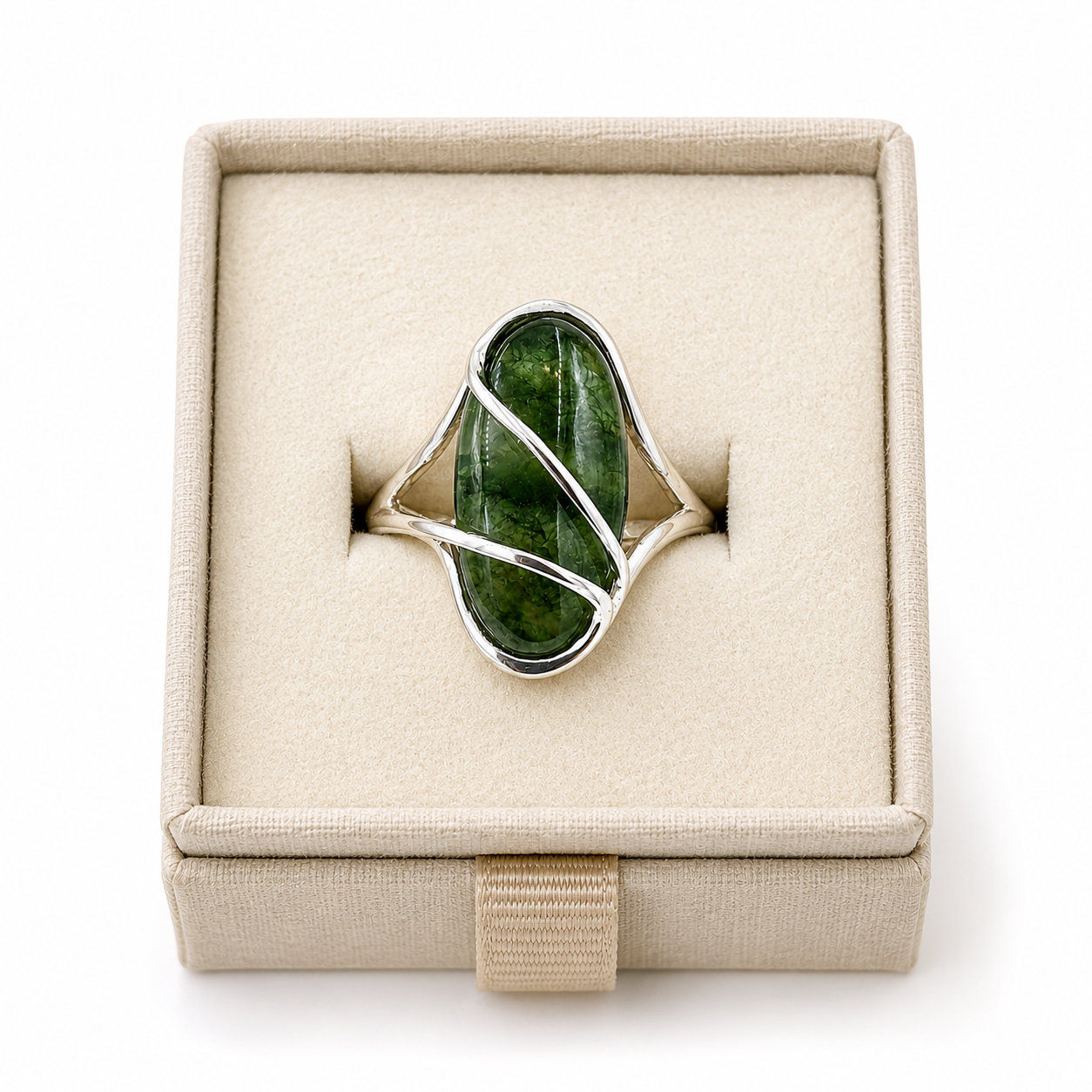 Sterling silver wire-wrap ring with an oval green cabochon gemstone displayed in a soft linen-colored jewelry box -Clover's Charm.