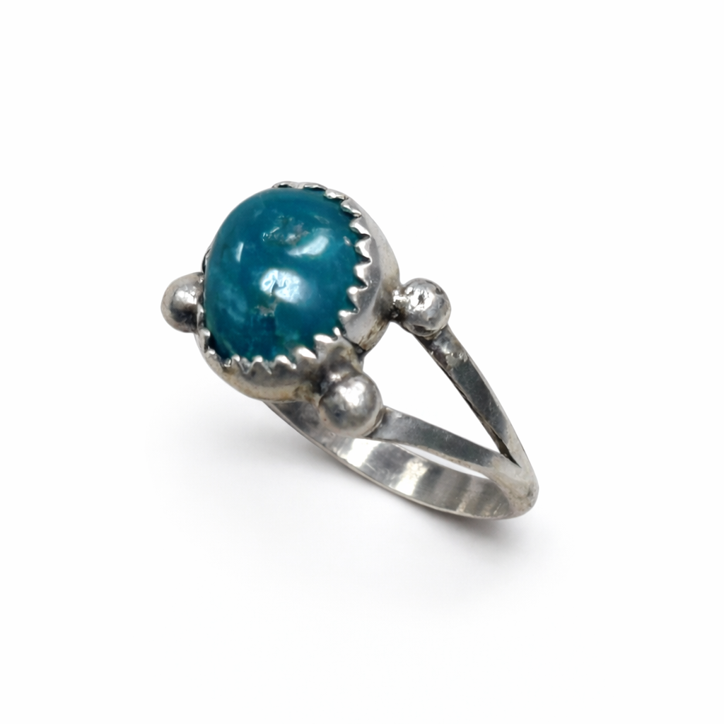 Silver ring with a blue gemstone on a white background