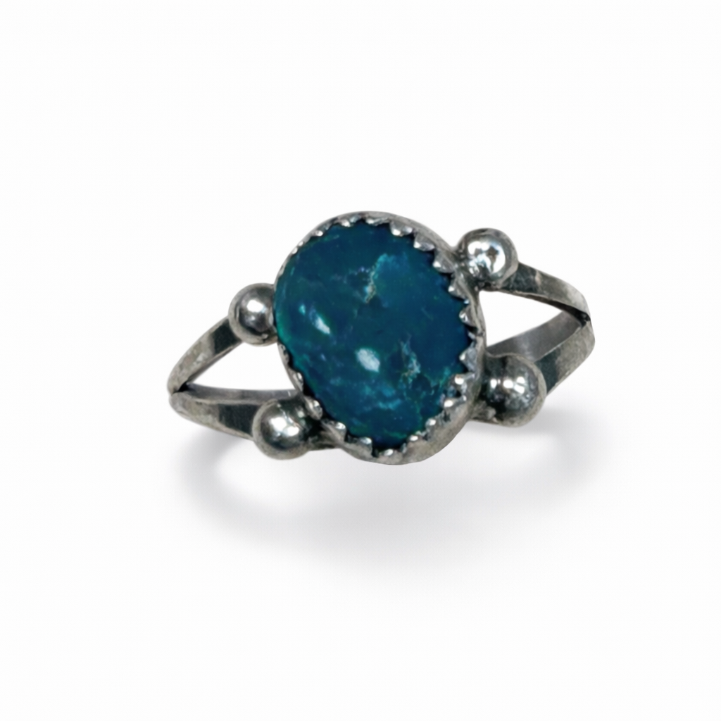 Silver ring with a blue gemstone on a white background