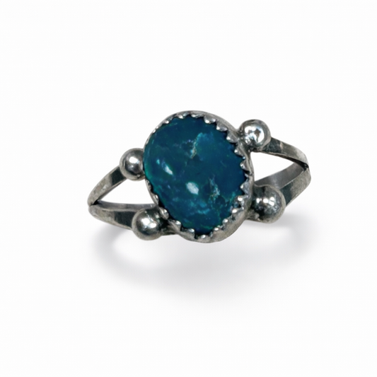 Silver ring with a blue gemstone on a white background