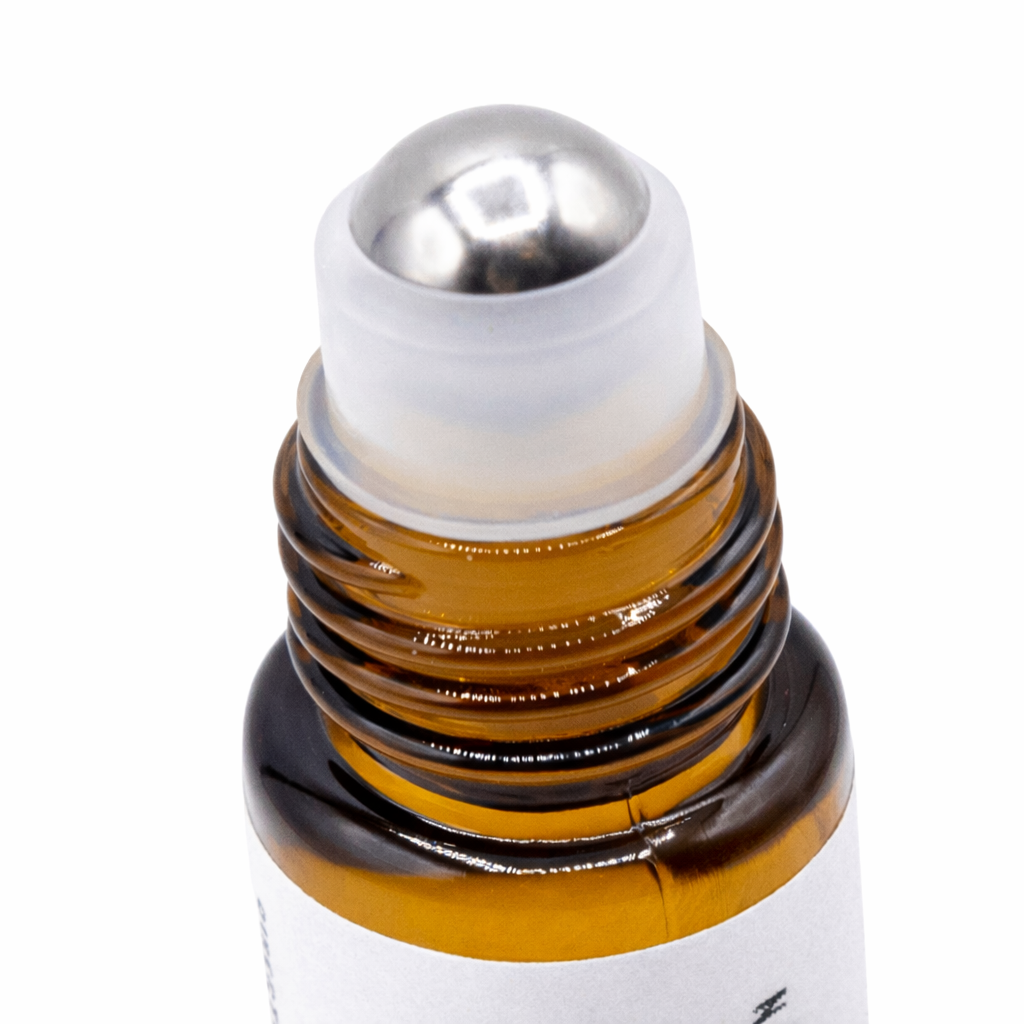 Lavender essential oil roll-on by, featuring a small glass applicator bottle with a rollerball cap - Clover's Charm