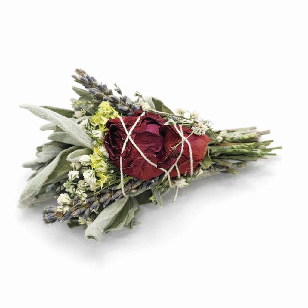Bouquet of dried flowers including red roses, lavender, and sage on a white background
- Clover's Charm