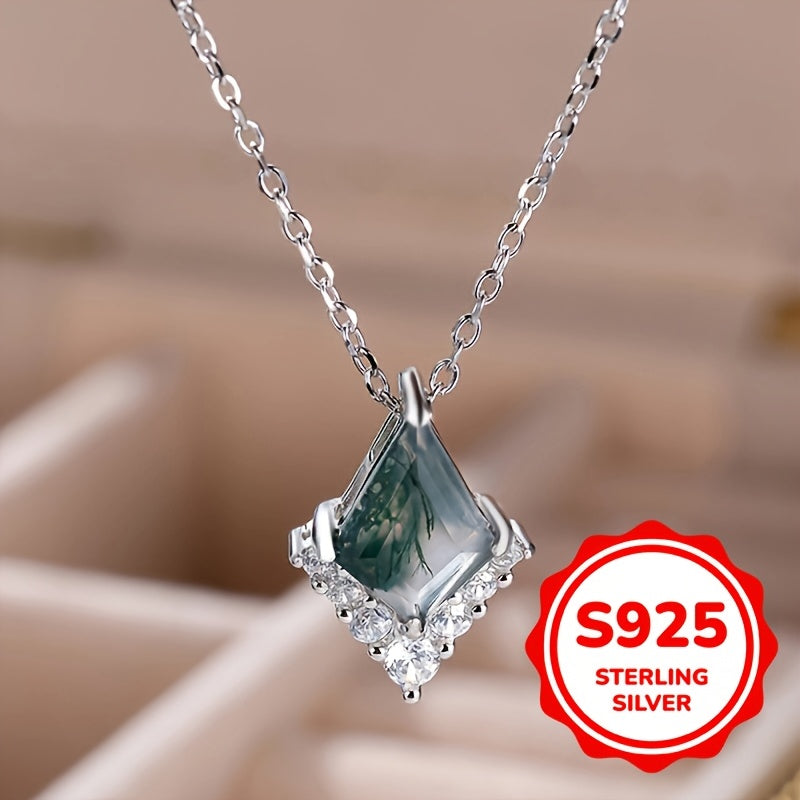 Silver necklace with a pendant on a blurred background, featuring an 'S925 Sterling Silver' label.