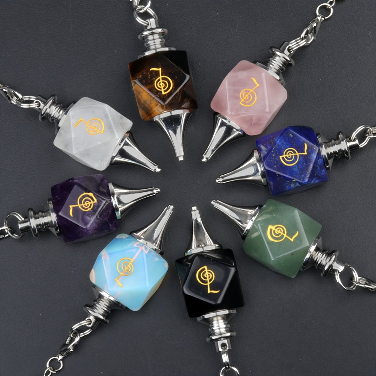 Colorful gemstone pendants arrayed in a circle on a dark background