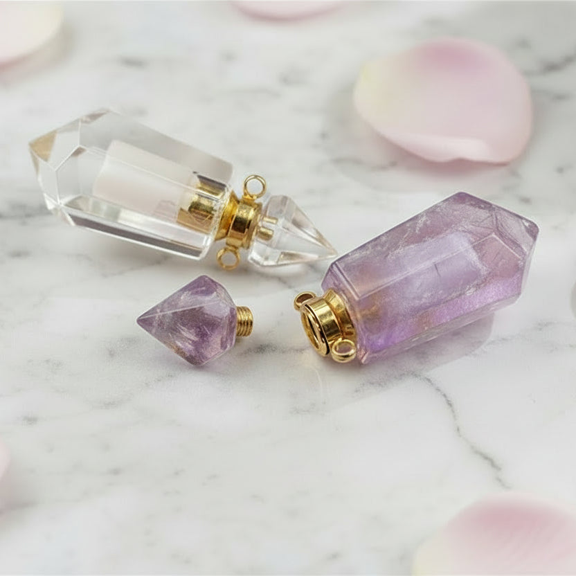 Natural Gems Stone Faceted Prism Perfume Bottle Pendants with gold plated stainless steel on a marble surface with pink rose petals. 