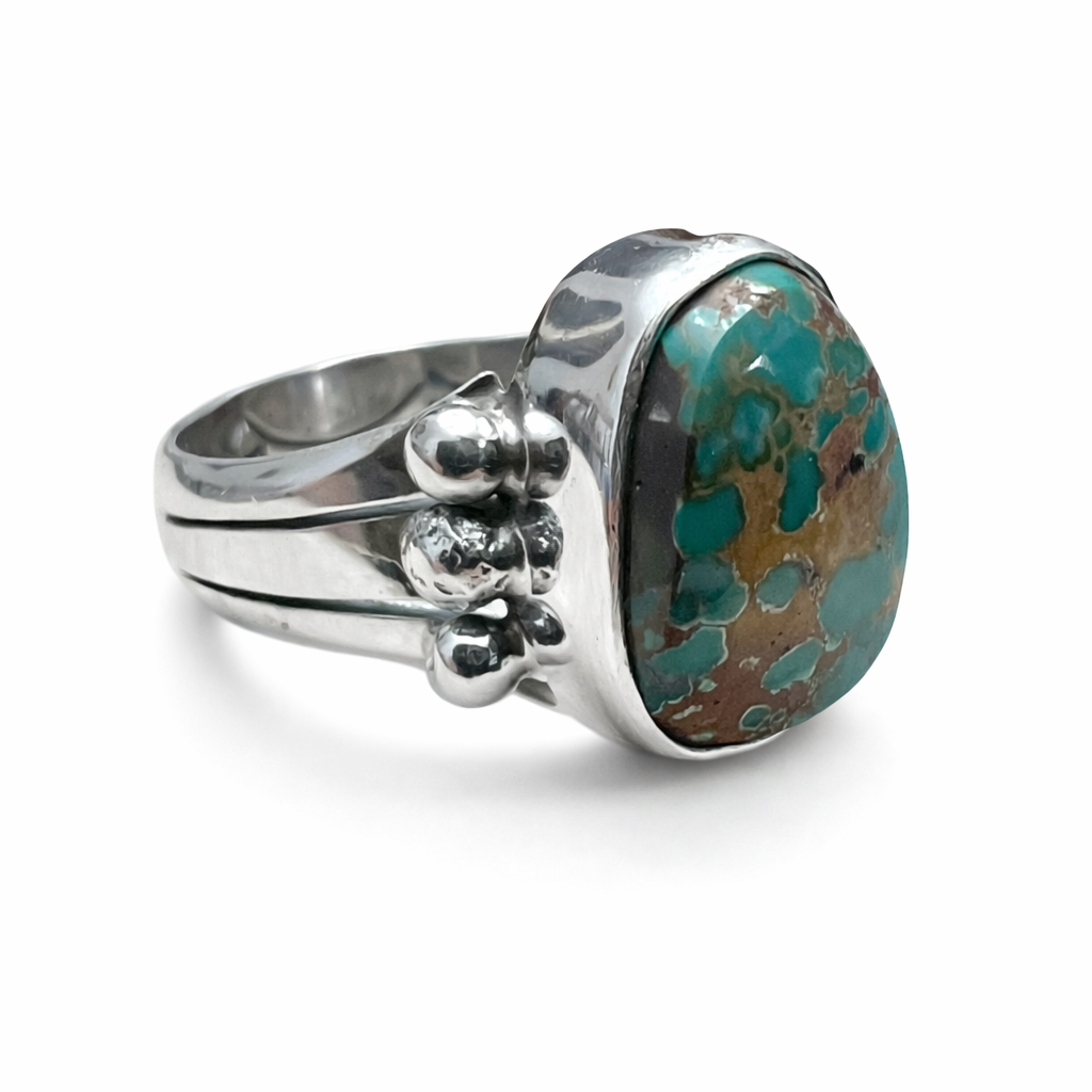 Sterling Silver ring with a large natural Royston turquoise stone on a white background
