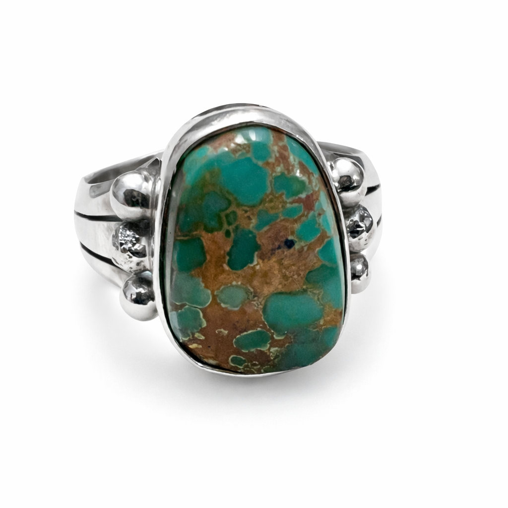 Natural Royston Turquoise ring with sterling silver band on a white background
