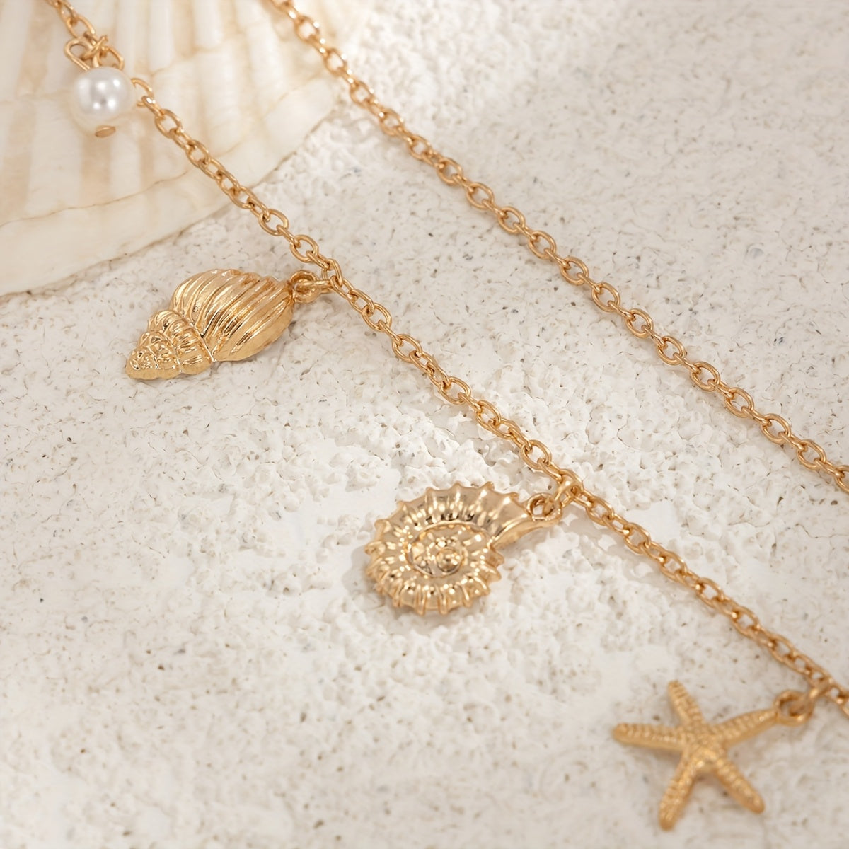 Ocean charm waist chain with gold seashell starfish turtle and pearl accents adjustable beach body chain belt for women close-up