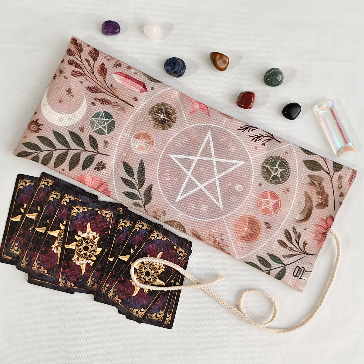 Set of tarot cards with a decorative cloth and crystals on a light background