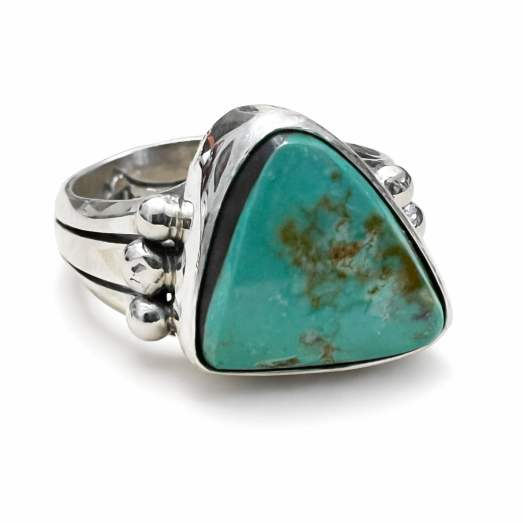 Silver ring with a large turquoise stone on a white background