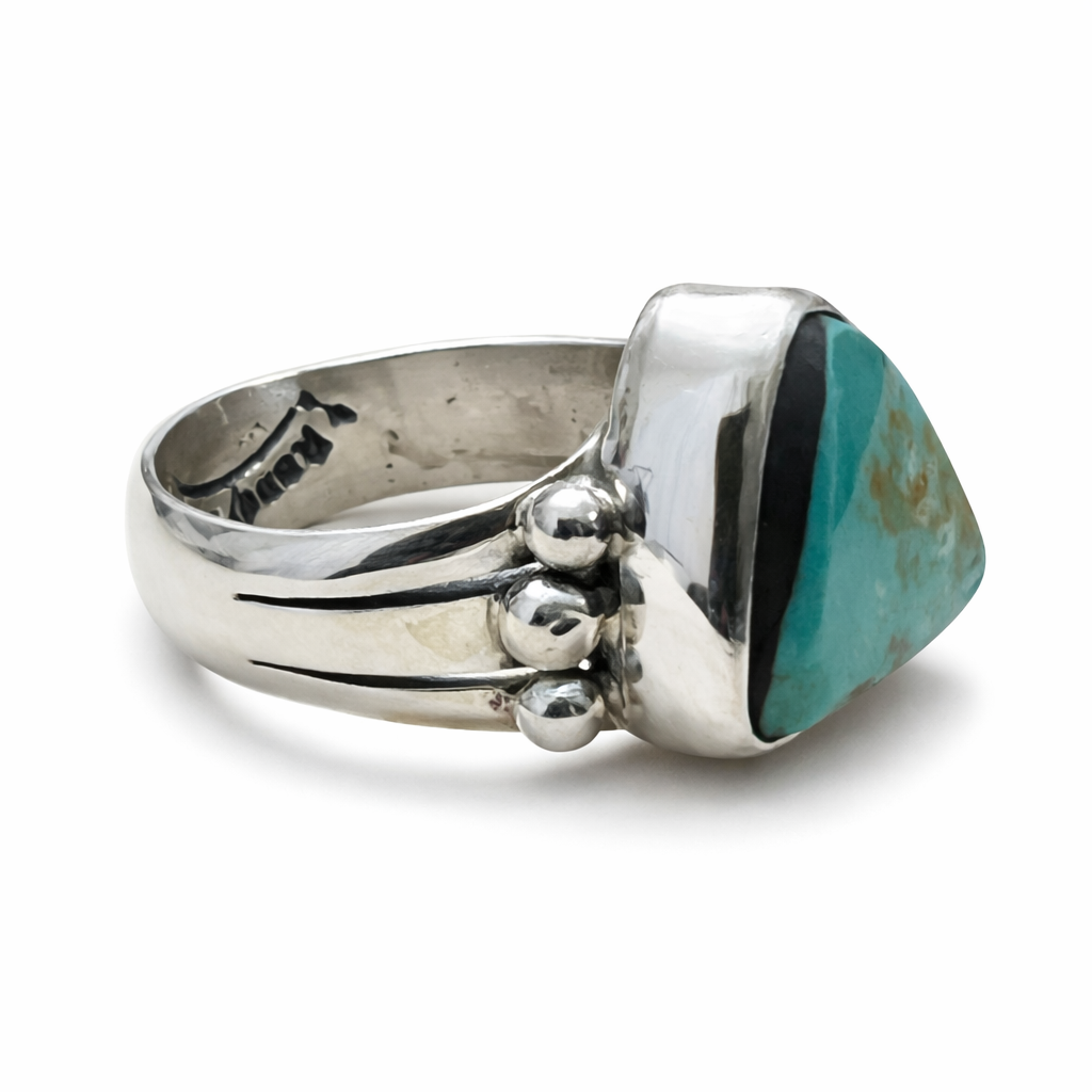 A Randy Billy Hallmark sterling silver ring with a turquoise stone on a white background