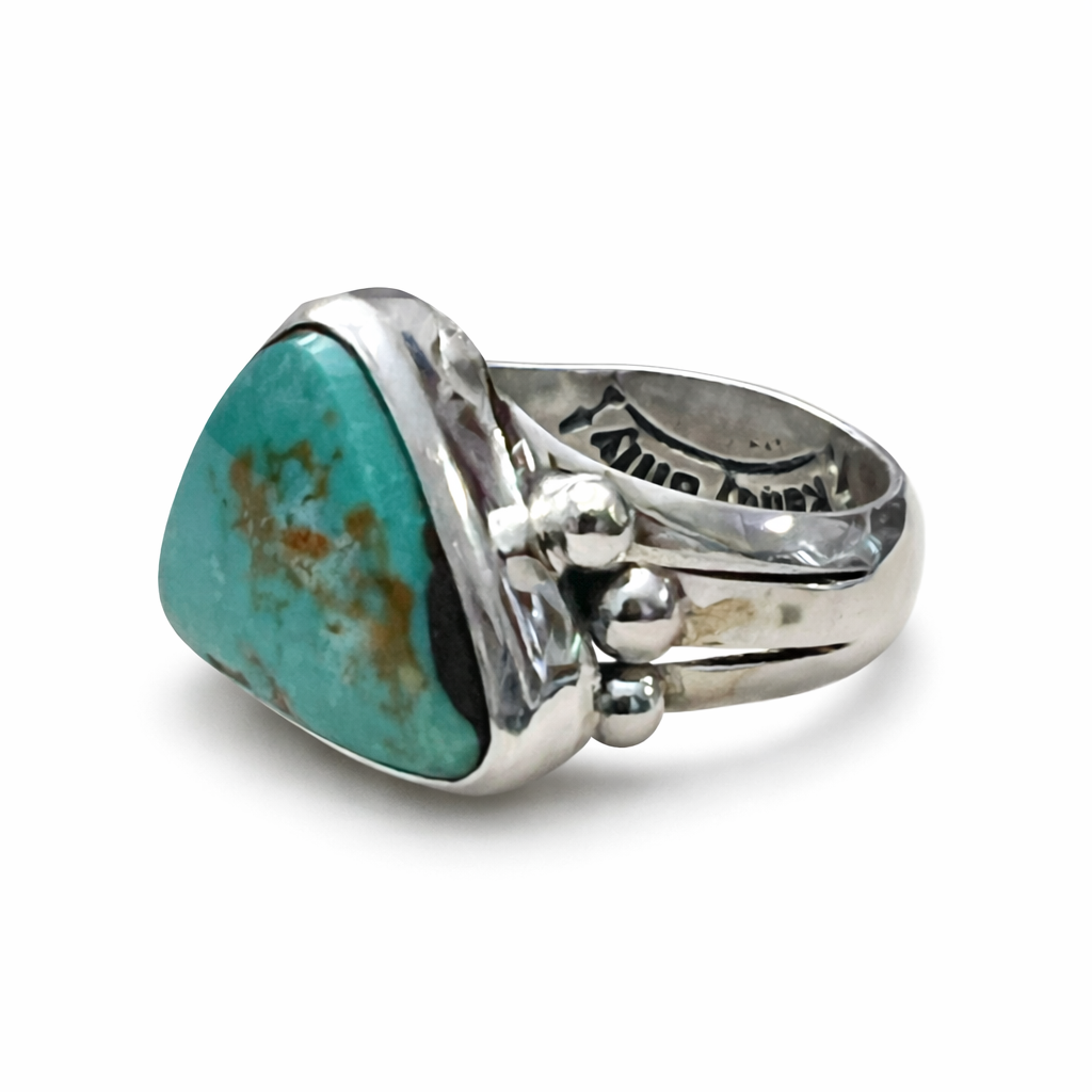 A Randy Billy Hallmark sterling silver ring with a turquoise stone on a white background