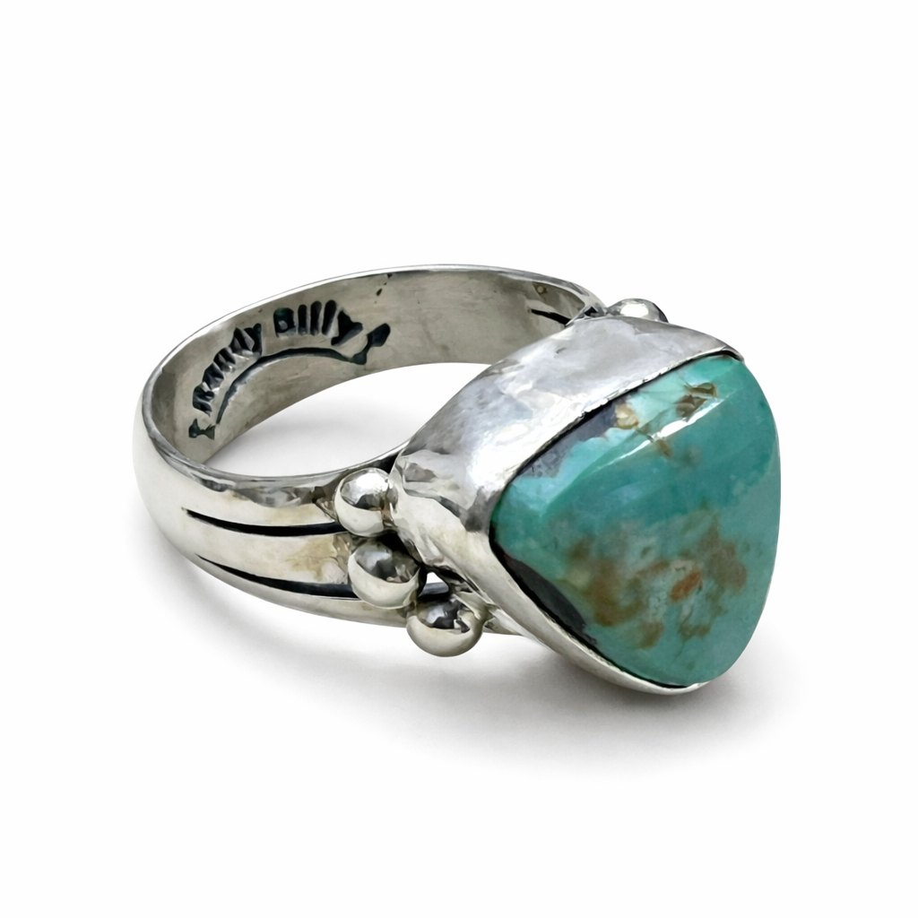 A Randy Billy hallmark sterling silver ring with a turquoise stone on a white background