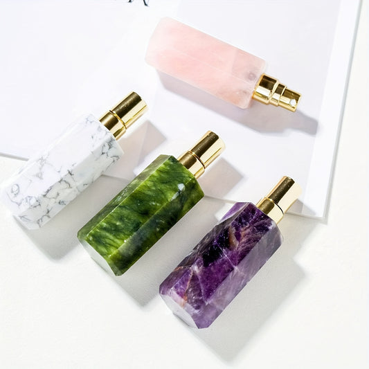 Refillable natural crystal stone perfume bottle in assorted crystal stones on a white surface.
