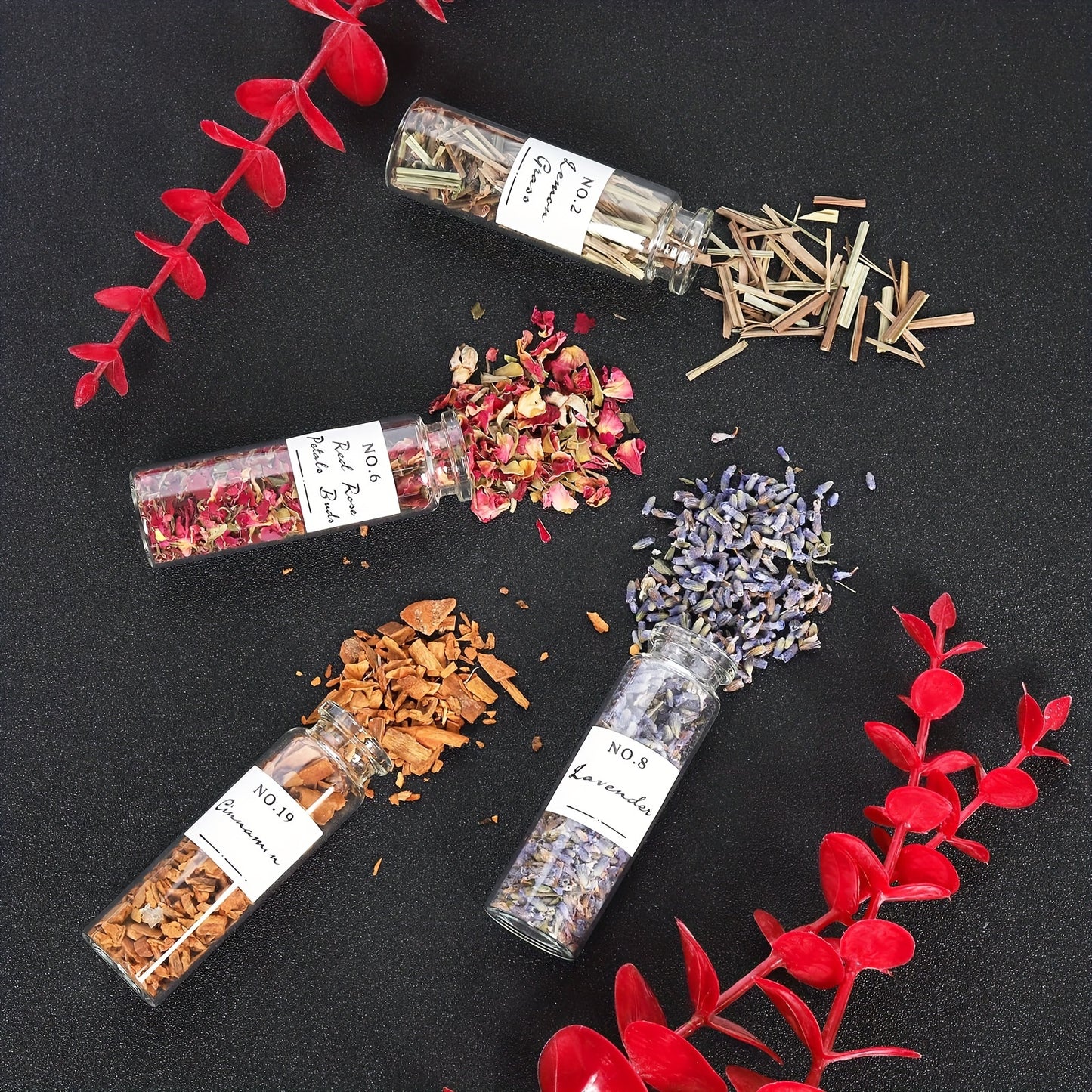 Ritual inspired botanical decor kit with spilled dried botanicals and glass vials on dark background