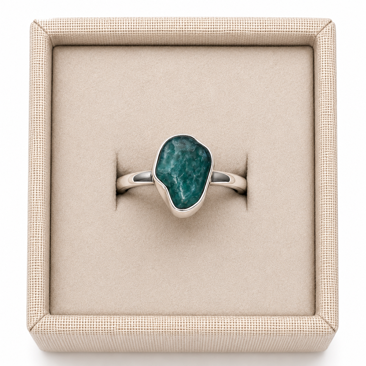 Rough emerald crystal sterling silver ring in display box on a white background. - Clover's Charm