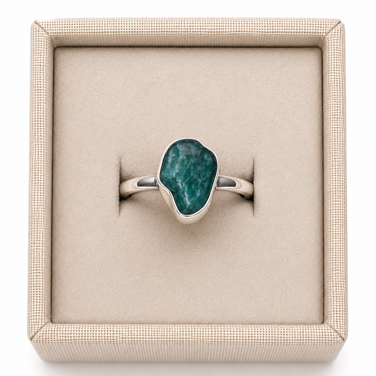 Rough emerald crystal sterling silver ring in display box on a white background. - Clover's Charm