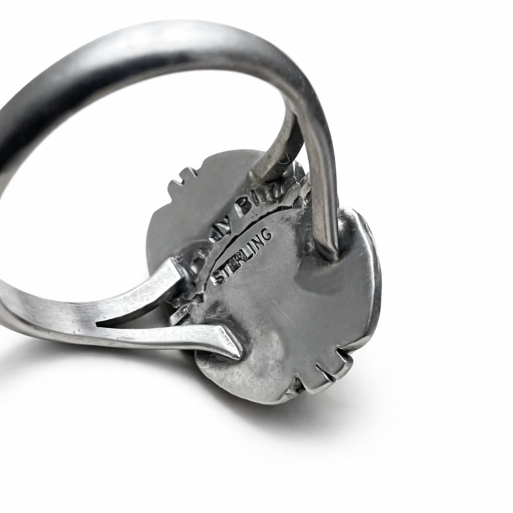 Close-up of the back of a Randy Billy Artisan sterling silver ring with 'Sterling' marking on a white background