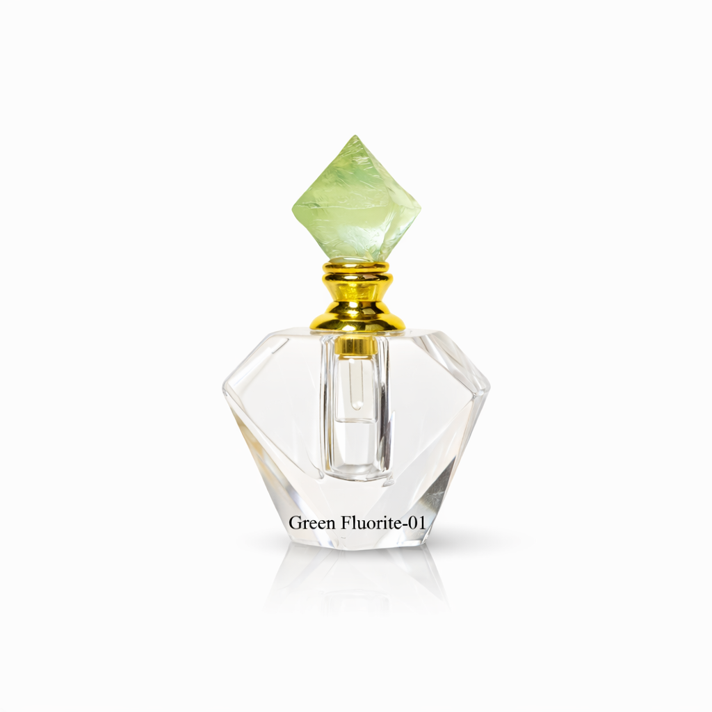 Crystal perfume bottle with green cap on a white background