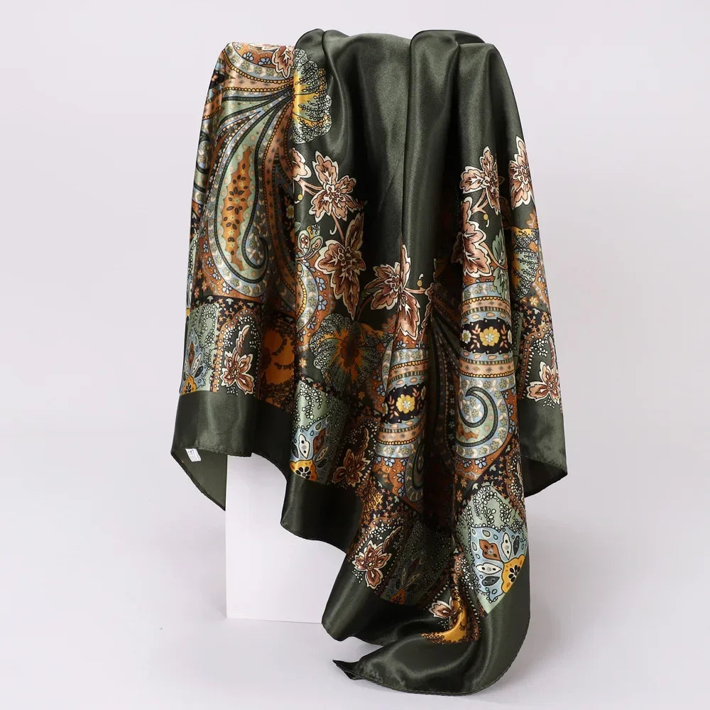 Green satin scarf with intricate floral and paisley patterns on a white background