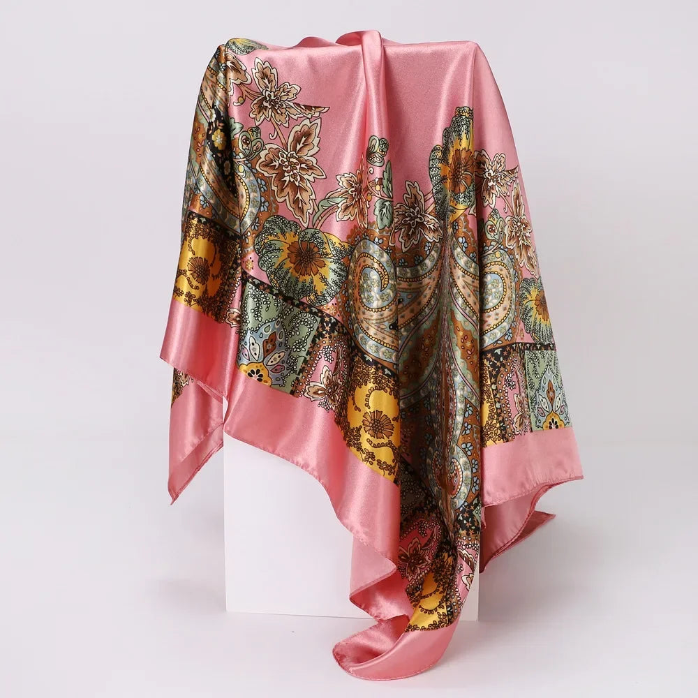 Pink scarf with intricate floral patterns on a white background