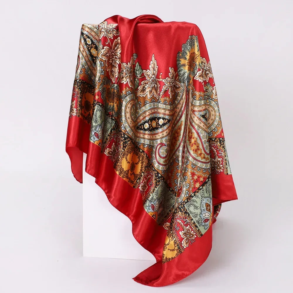 Red scarf with intricate paisley pattern on a white background