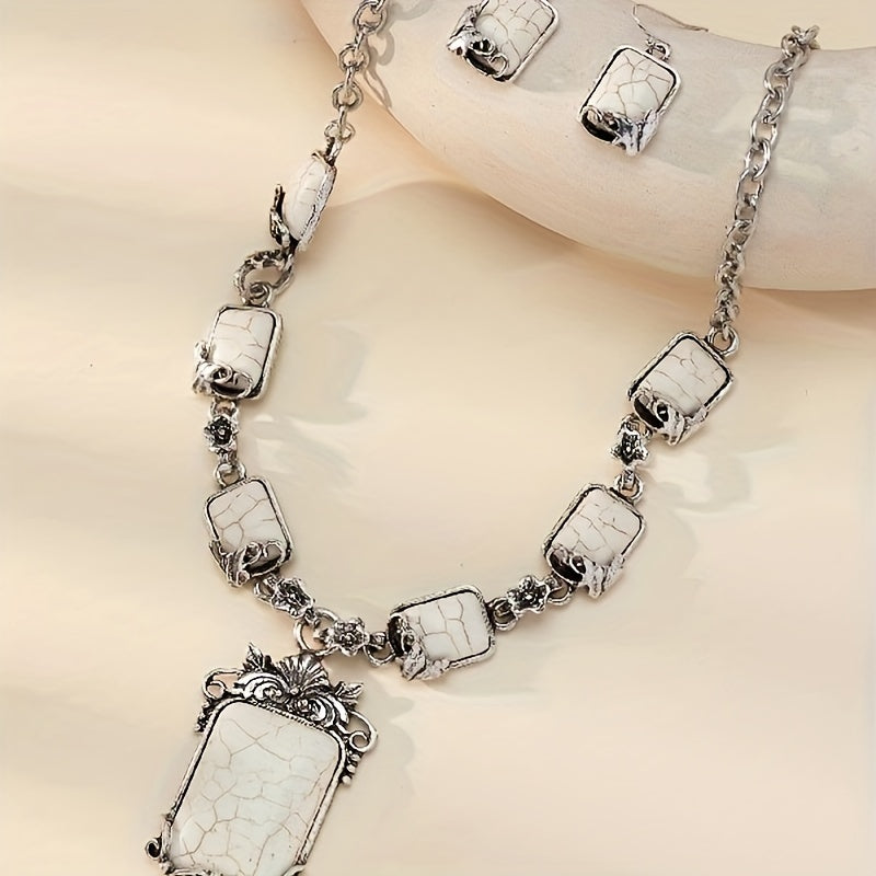 Silver necklace with white stone pendants on a beige background