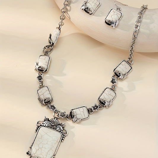 Silver necklace with white stone pendants on a beige background
