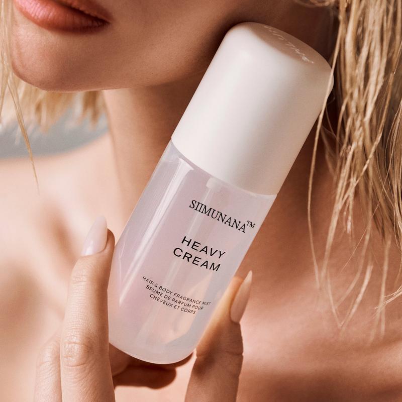 Simuna Heavy Cream Vanilla Bliss Body and Hair Perfume Mist 3.38 oz bottle held in hand
