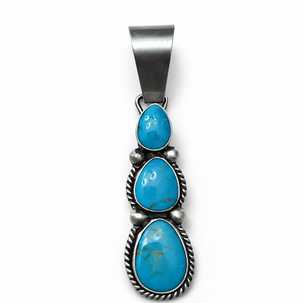 Turquoise pendant with silver setting on a white background