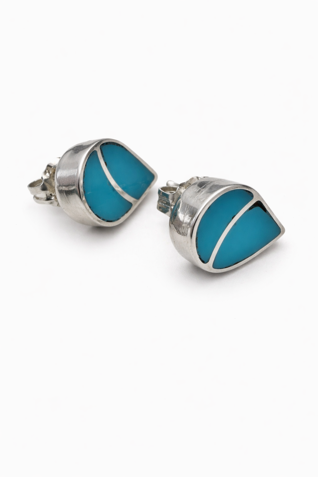 Pair of turquoise and silver earrings on a white background. -Clover's Charm