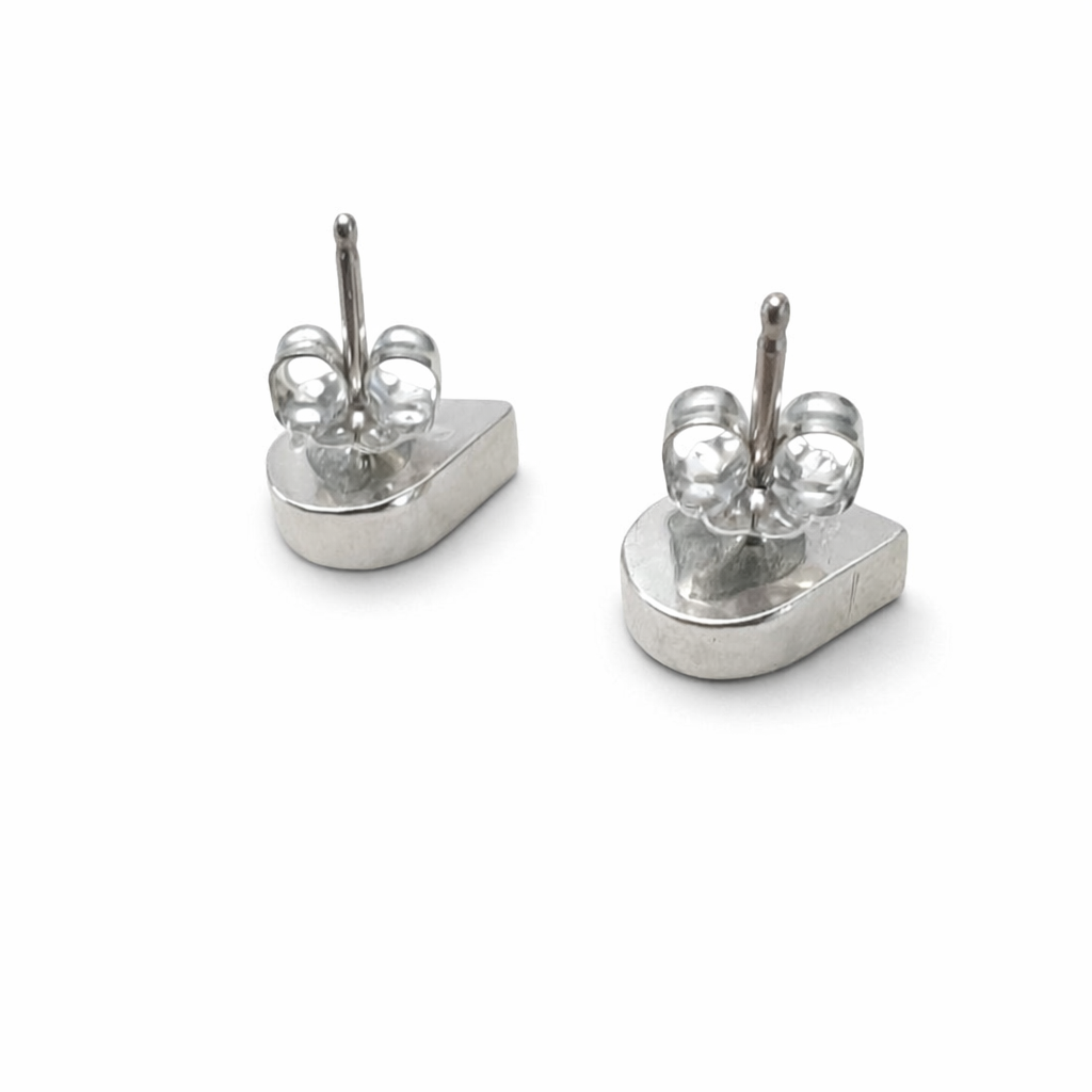 Pair of silver earrings on a white background. -Clover's Charm
