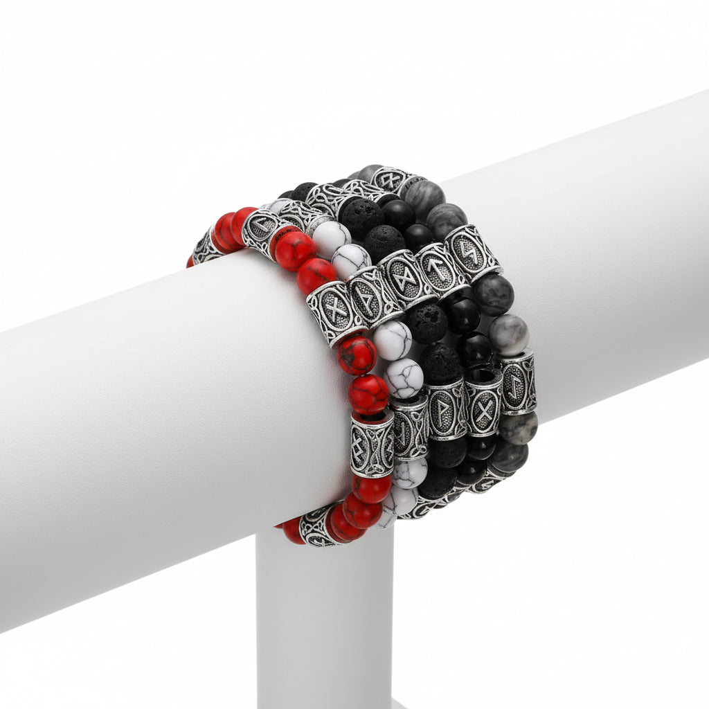 Set of beaded bracelets with red, white, and black stones on a dark background