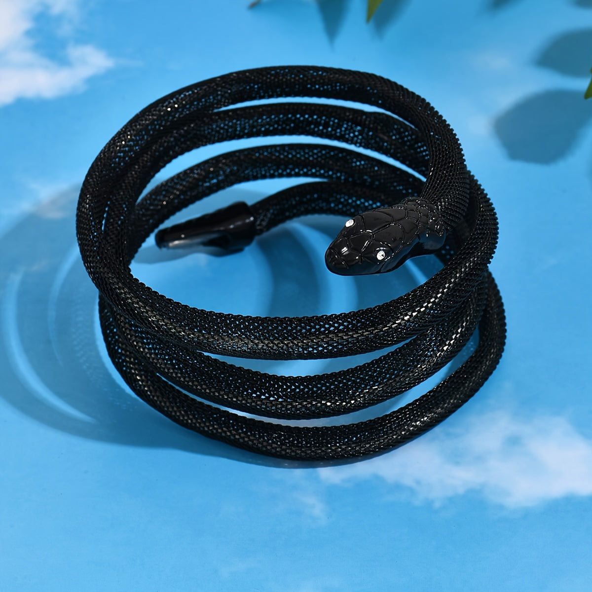 Vintage black snake statement bracelet displayed coiled with textured black finish