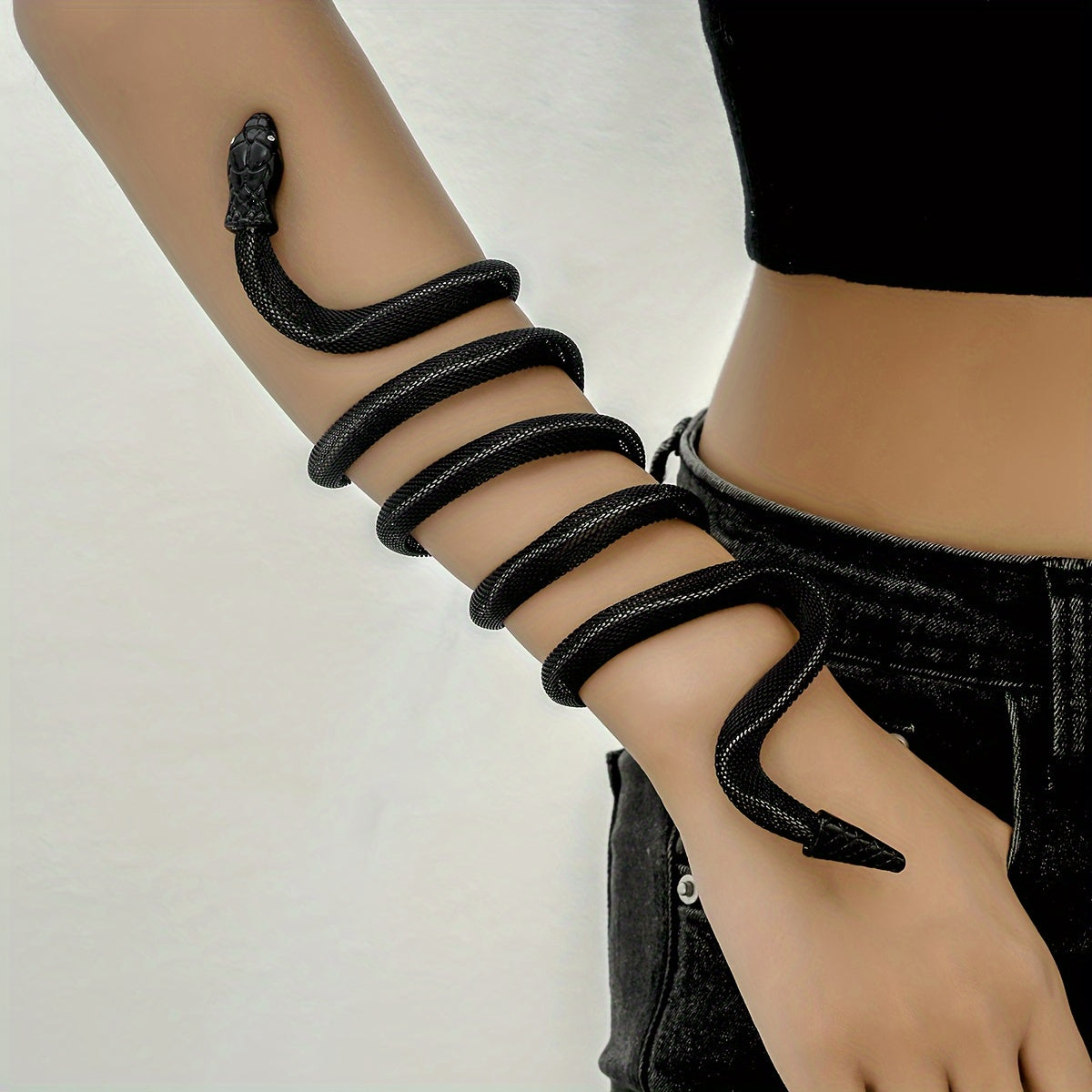 Vintage black snake statement bracelet worn wrapped around wrist with bold sculptural design