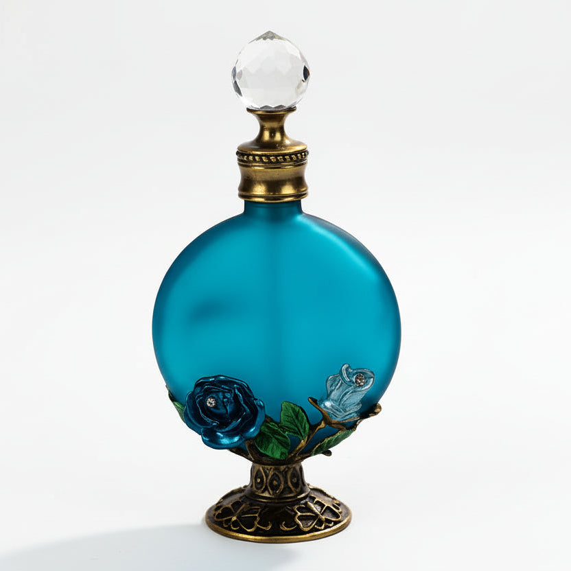 Vintage style blue rose glass perfume bottle with raised rose pattern and blue glass finish on a white background.