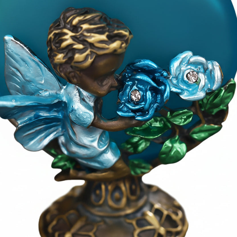 close up of a Vintage style blue  rose glass perfume bottle with raised rose pattern and blue glass finish