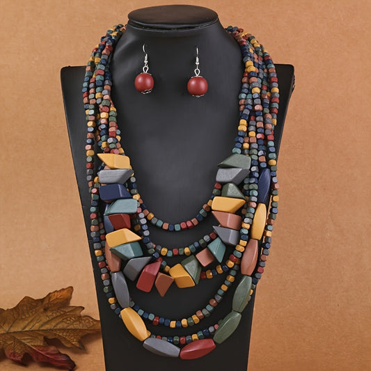 Colorful beaded necklace and earrings on a black mannequin against a brown background