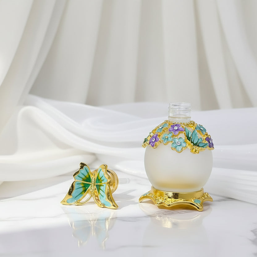 Vintage style glass perfume bottle with butterfly stopper and drop rod on a white background.
