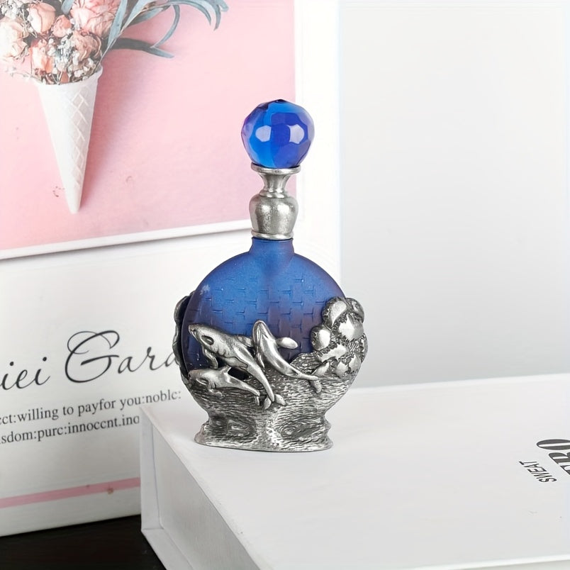 Vintage style glass perfume bottle with dolphin design and blue glass body on a product display package.
