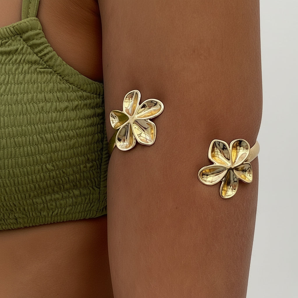 Vintage style gold flower open cuff bracelet worn on arm with polished floral design
