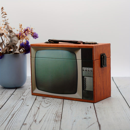 Vintage-style television styled storage box on a wooden table with a plant in the background