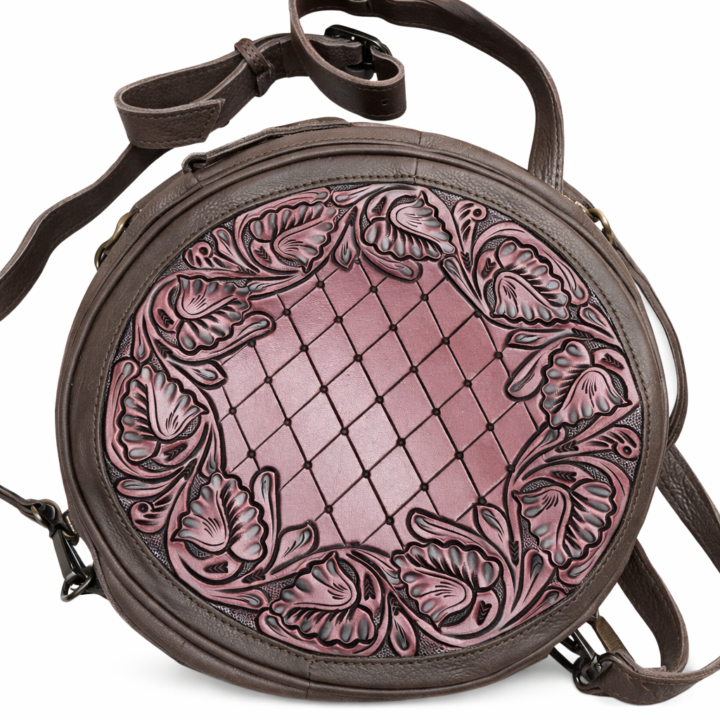 Round leather bag with intricate floral patterns on a white background