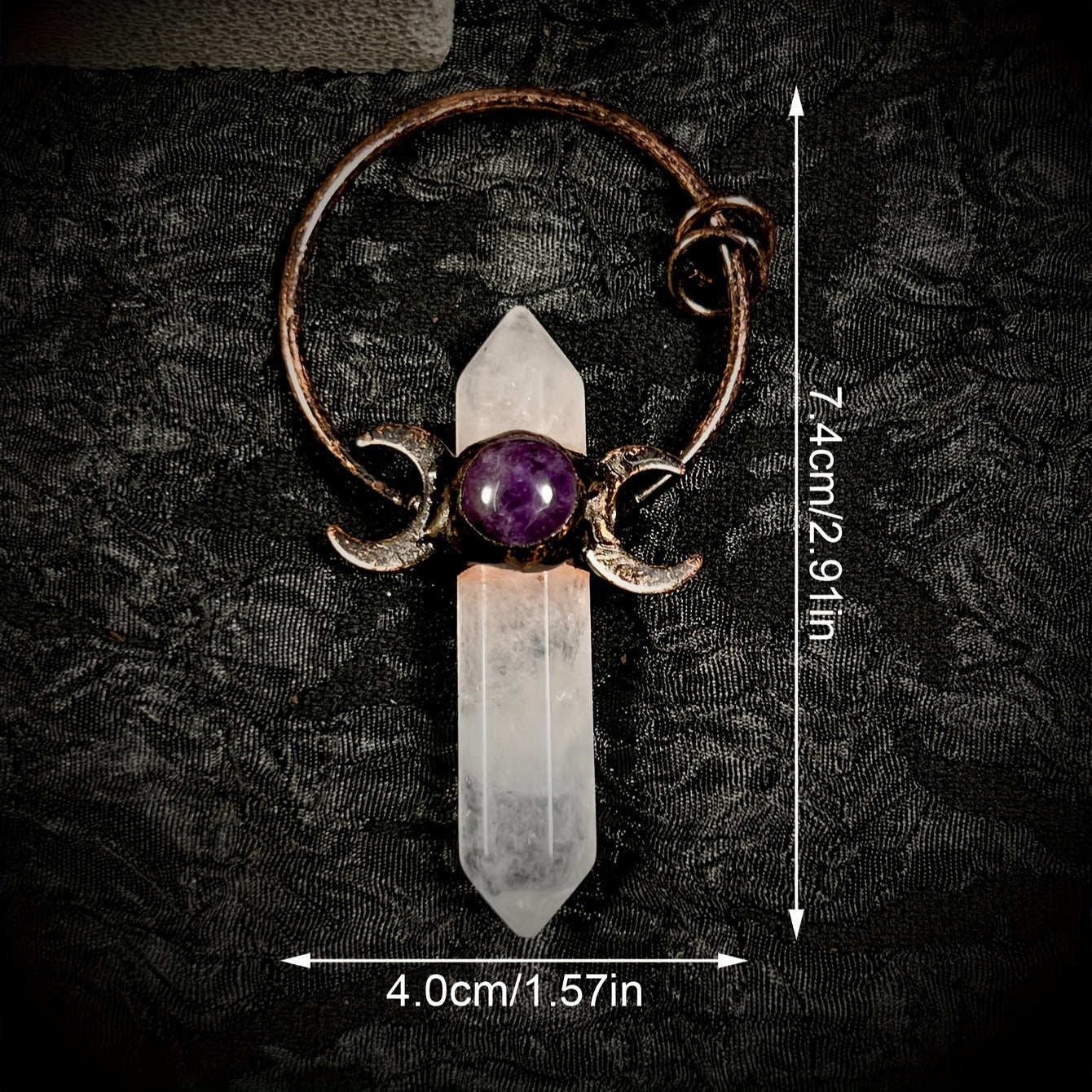Amulet with crystal and purple stone on a dark textured background featuring measurements