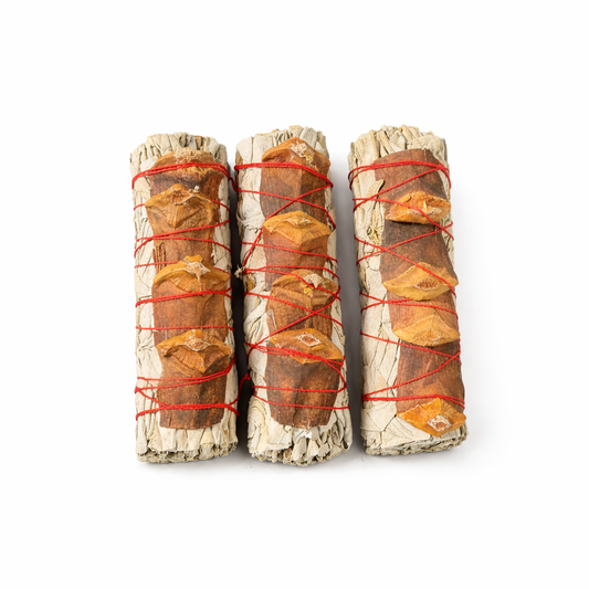 Three sage & pine smudge sticks wrapped with red string on a white background - Clover's Charm
