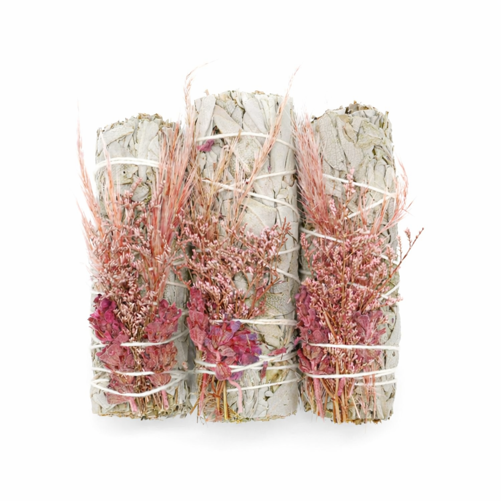 Three bundles of sage wrapped with pink flowers on a white background
- Clover's Charm