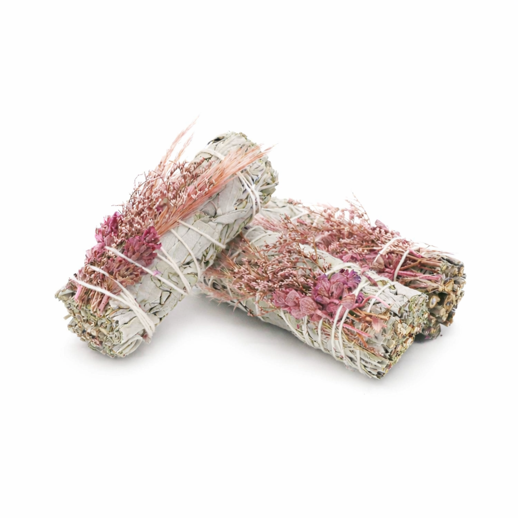 Two bundles of sage and rosemary smudge sticks on a white background
- Clover's Charm
