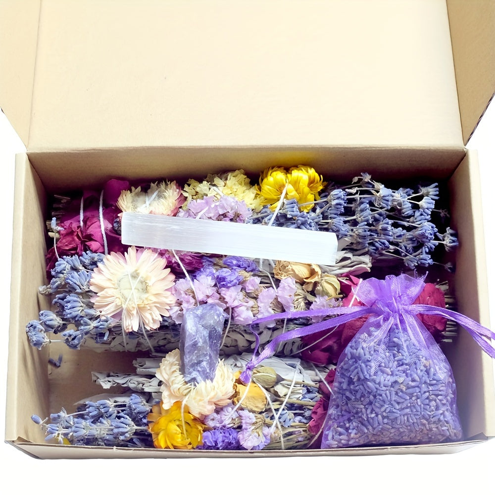 Box containing dried flowers, sage and a couple crystals, and a lavender bag on a white background