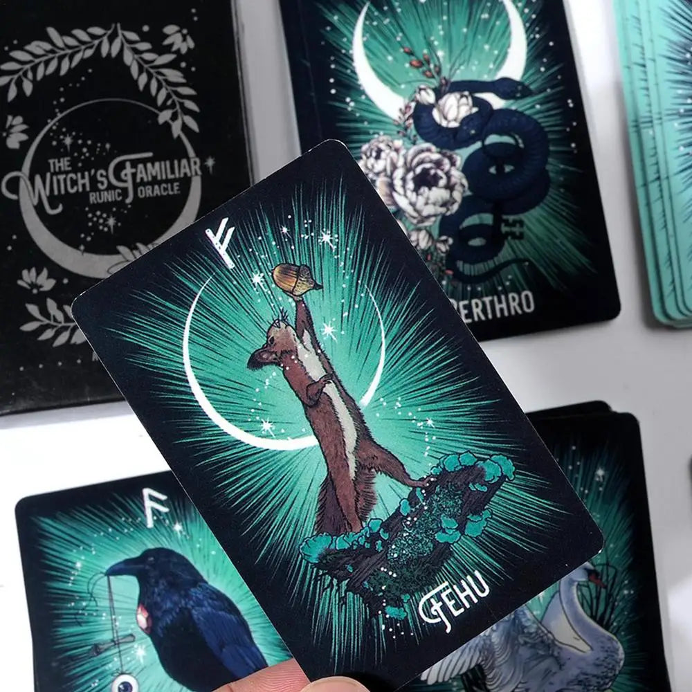 Tarot card with a green and blue design featuring a bear and a crescent moon, held by a hand.